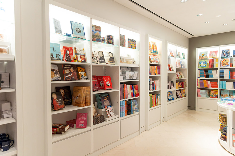 Various items on shelves are shown in the Kauffman Center Gift Shop.